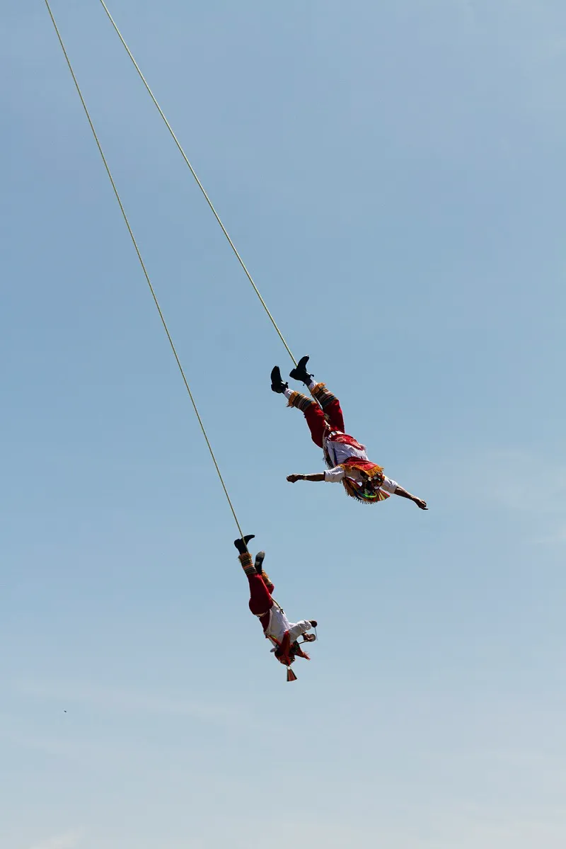 Bungee jumper in freefall over the river, seen from above