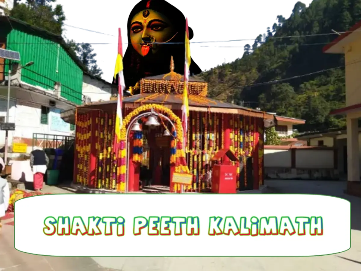 Kalimath temple beautifully decorated with marrygold flowers and maa kali image in the background and test written - Shakti Peeth Kalimath