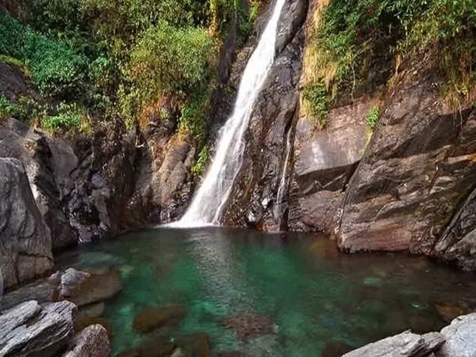 Bhagsunag waterfall falling into a green pool near McLeodganj