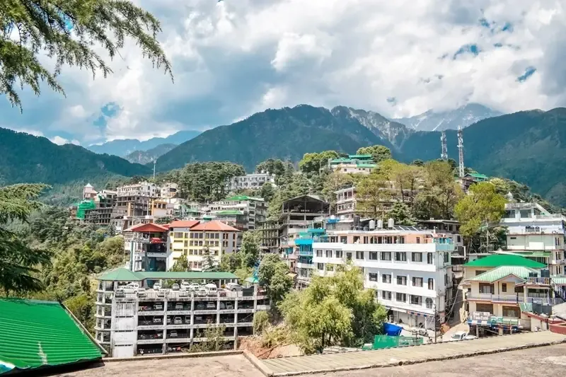 McLeodganj town on the hillside with the Dhauladhar range behind