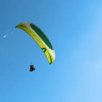 Yellow paraglider flying at Bir