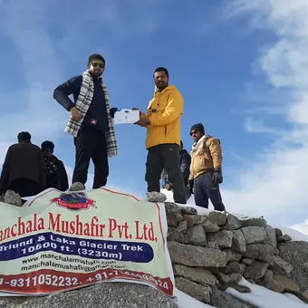 Manchala Mushafir group with the company banner at Laka Glacier, 3,230 m