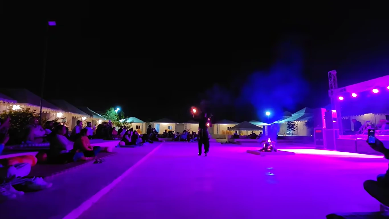New Year's Eve stage show with guests seated around a lit-up resort lawn in Jaipur