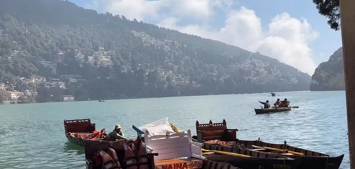Rowing boats on Naini Lake with the hillside town of Nainital behind