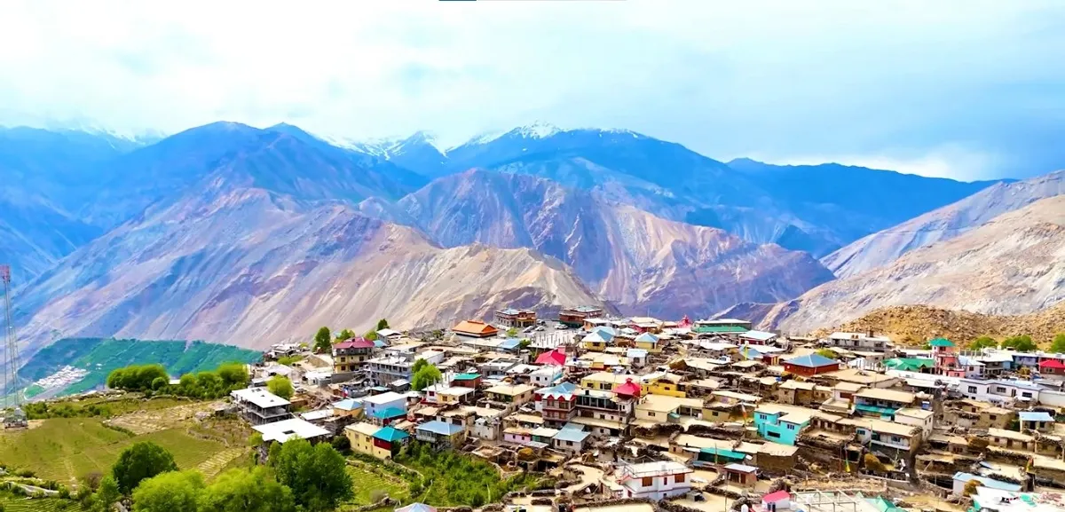 Spiti village with flat-roofed houses below barren mountains
