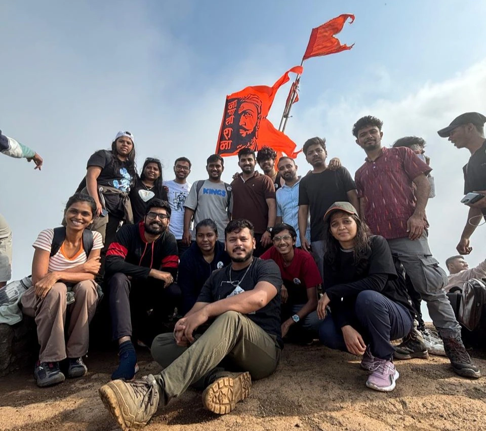 group posing at Harishchandragad fort with shivaji flag