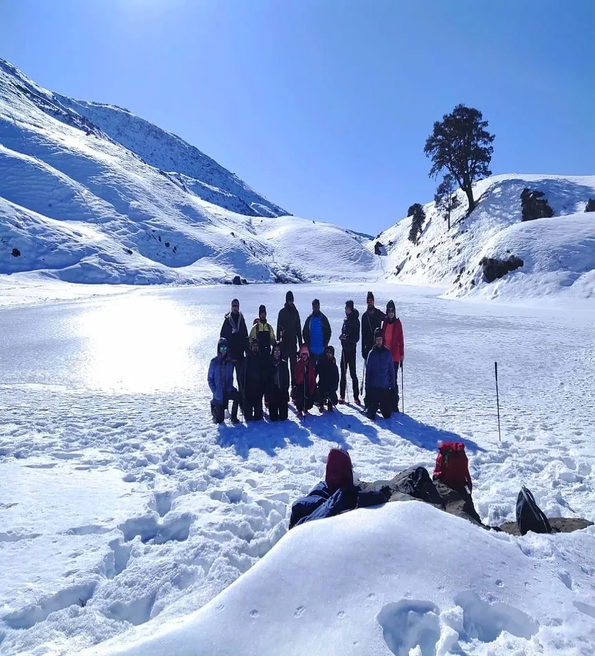 Trekkers posing at Brahmatal lake