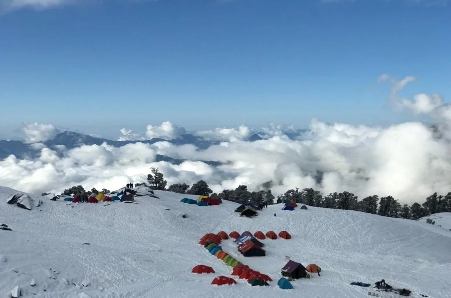 Full view from the snow covered Brahmatal trek and clouds floating along the camping site of the trek