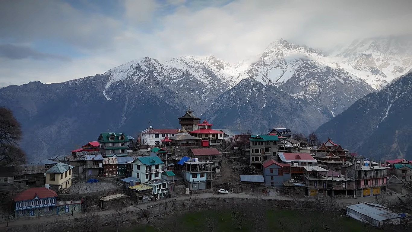 Kalpa village with snow-capped mountains rising behind the houses