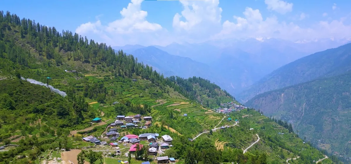 terraced village and forested slopes in the Tirthan Valley near Jibhi