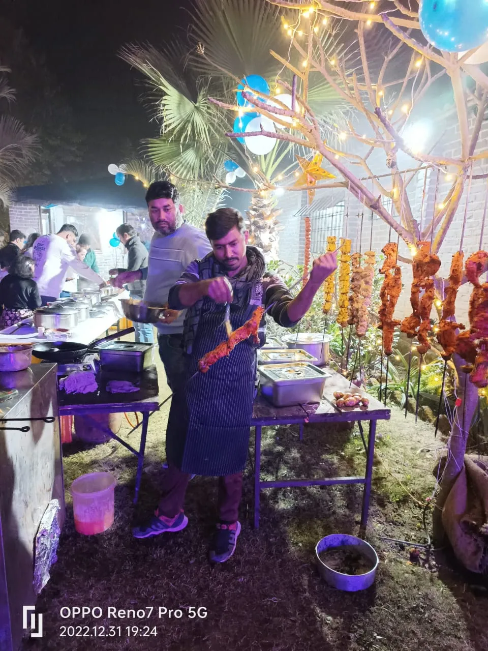 Chefs grilling barbecue skewers at the New Year's Eve dinner buffet