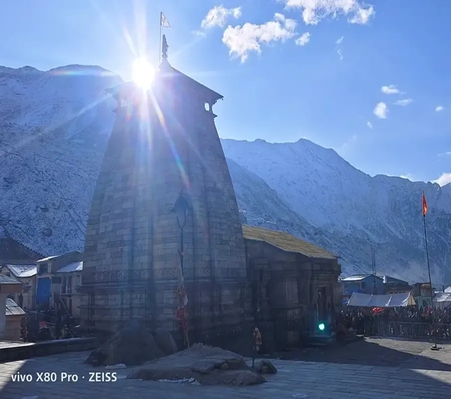 Kedarnath Temple in the morning sun with snow-covered peaks behind