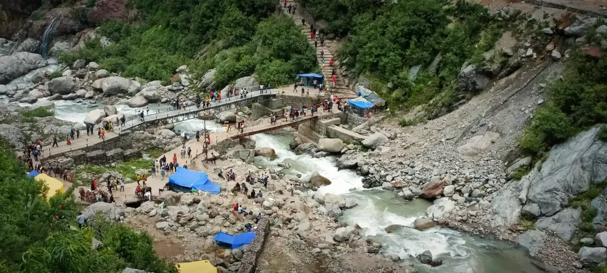 Pilgrims walking beside the Mandakini river on the Kedarnath trek from Gaurikund