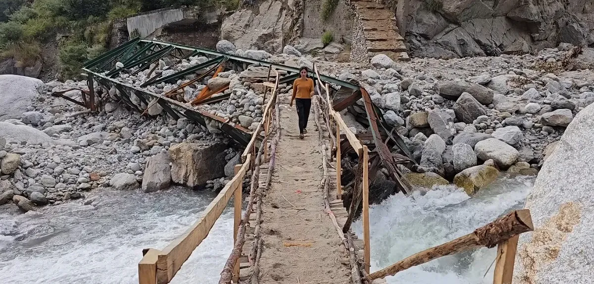 Wooden footbridge over a rocky mountain stream on the Madhyamaheshwar trail