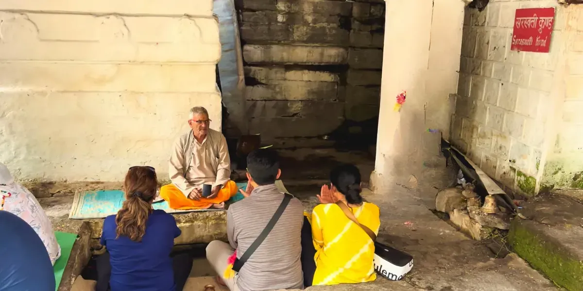 Priest performing a puja for a family beside Saraswati Kund at Triyuginarayan Temple