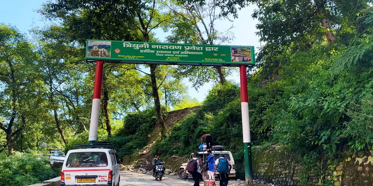 Entrance gate on the road to Triyuginarayan Temple, surrounded by green forest